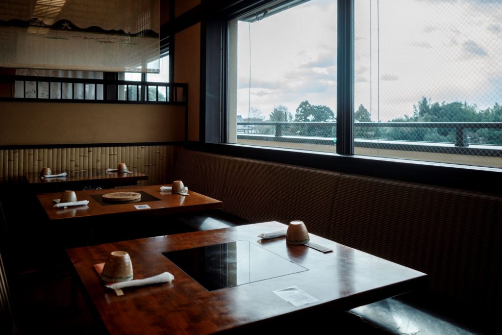 Low tables by a garden, Kyoto.
