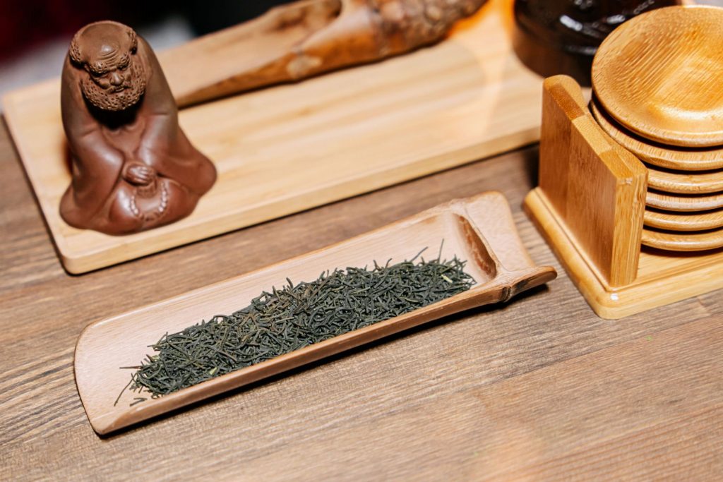 Loose tea leaves on a tray.